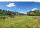 Picturesque fenced meadow featuring a modern chicken coop with run on a sunny day at 96 Landers Ne Rd, Rydal, GA 30171