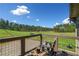 Relaxing deck with comfortable seating and a stunning view of the lush landscape and open fields at 96 Landers Ne Rd, Rydal, GA 30171
