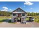 Unique barn-style home with parking, covered area, small balcony, and well-maintained gravel driveway at 96 Landers Ne Rd, Rydal, GA 30171
