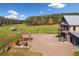 Exterior view features a barn with an outdoor patio area with furniture, hot tub and grill at 96 Landers Ne Rd, Rydal, GA 30171