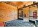 Rustic horse stall featuring wood paneling, metal gate and ceiling fan at 96 Landers Ne Rd, Rydal, GA 30171