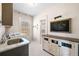 Bright laundry room with modern appliances, cabinetry, and a charming chalkboard accent at 96 Landers Ne Rd, Rydal, GA 30171