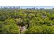 Stunning aerial view of a lush estate with a city skyline backdrop, blending nature and urban living at 289 W Paces Ferry Nw Rd, Atlanta, GA 30305