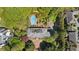 Stunning aerial view of the property featuring a pool, landscaping, and the house nestled among lush greenery at 289 W Paces Ferry Nw Rd, Atlanta, GA 30305