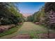 Lush backyard with green lawns, manicured shrubs and blooming flowers, creating a serene outdoor space at 289 W Paces Ferry Nw Rd, Atlanta, GA 30305