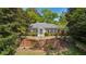 Elegant brick home with a classic facade, featuring a stately brick wall and lush landscaping at 289 W Paces Ferry Nw Rd, Atlanta, GA 30305
