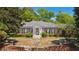 Elegant brick home with stately columns, black shutters, and professionally landscaped front yard at 289 W Paces Ferry Nw Rd, Atlanta, GA 30305