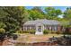 Classic brick home with a columned entrance, shutters, and a circular driveway surrounded by mature landscaping at 289 W Paces Ferry Nw Rd, Atlanta, GA 30305