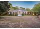 Stately brick home with a wide driveway, boasting a grand entrance with columns and mature landscaping at 289 W Paces Ferry Nw Rd, Atlanta, GA 30305