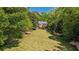 Lush front yard with manicured lawn and charming brick home, framed by mature trees and colorful azaleas at 289 W Paces Ferry Nw Rd, Atlanta, GA 30305