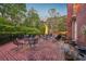 Charming brick patio with outdoor seating, lush greenery, and an inviting ambiance at 289 W Paces Ferry Nw Rd, Atlanta, GA 30305