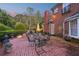 Charming brick patio with elegant outdoor seating, lush greenery, and beautiful brick home exterior at 289 W Paces Ferry Nw Rd, Atlanta, GA 30305