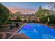 Beautiful pool with lounge chairs and umbrella-shaded tables, situated behind this gorgeous brick home at 289 W Paces Ferry Nw Rd, Atlanta, GA 30305