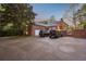 Rear of home with attached garage, spacious driveway, and beautifully landscaped yard at 289 W Paces Ferry Nw Rd, Atlanta, GA 30305