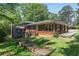 Charming brick home with mature trees, a manicured lawn, and multiple entry points at 3007 Octavia Cir, Marietta, GA 30062