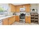 Well-lit kitchen features light wood cabinets, stainless steel appliances, and tile flooring at 3007 Octavia Cir, Marietta, GA 30062
