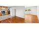 Open concept kitchen with light wood cabinets flowing into an adjacent room with hardwood flooring at 3007 Octavia Cir, Marietta, GA 30062