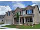 Charming two-story brick home featuring a covered front porch and a two-car garage at 3305 Linstead Ct, Loganville, GA 30052