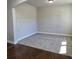 A carpeted living room with base trim and natural light at 3305 Linstead Ct, Loganville, GA 30052