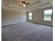 Expansive main bedroom features trey ceiling, ceiling fan, and large windows, creating a bright and airy space at 3305 Linstead Ct, Loganville, GA 30052