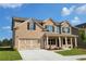 Beautiful two-story home with brick facade, attached garage, and manicured lawn at 3325 Linstead Ct, Loganville, GA 30052