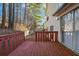 Wooden back deck with a red-painted railing and sliding glass door providing outdoor relaxation space at 939 Redan Trce, Stone Mountain, GA 30088