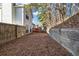 View of the backyard with a wooden deck, fencing, and a retaining wall, creating a private outdoor space at 939 Redan Trce, Stone Mountain, GA 30088