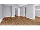 Bedroom with wood-look flooring, neutral walls, and white trim with 2 doors leading to bathrooms at 939 Redan Trce, Stone Mountain, GA 30088
