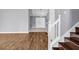Inviting entryway featuring hardwood floors, staircase with white railing, and an open view to the living spaces at 939 Redan Trce, Stone Mountain, GA 30088