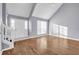 Bright living room with high ceilings, large window, hardwood floors, and staircase with white railing at 939 Redan Trce, Stone Mountain, GA 30088