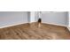 View of the living room showcasing new hardwood floors with a stairway and white trim throughout at 939 Redan Trce, Stone Mountain, GA 30088
