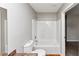 Bathroom with tub-shower, toilet, and vanity, complemented by neutral walls and flooring at 1626 Cobbs Creek Ln, Decatur, GA 30032