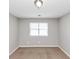 A bedroom with a window that provides natural light and a neutral carpet at 1626 Cobbs Creek Ln, Decatur, GA 30032