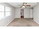 Bedroom with a window, a ceiling fan and attached bathroom, all enhanced by neutral walls at 1626 Cobbs Creek Ln, Decatur, GA 30032