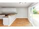 Bright kitchen with hardwood floors, bar seating, and sliding glass doors at 1626 Cobbs Creek Ln, Decatur, GA 30032