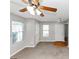 Inviting living room featuring neutral paint, a ceiling fan and bright windows at 1626 Cobbs Creek Ln, Decatur, GA 30032