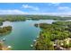 Aerial view showcasing the lake surrounded by lush greenery and waterfront properties at 4290 Bobbins Way, Cumming, GA 30041