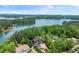 Stunning aerial view of the house with lake access and lush greenery at 4290 Bobbins Way, Cumming, GA 30041