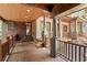 Expansive covered back porch showcasing wood floors, stone columns, and views of the lush backyard at 4290 Bobbins Way, Cumming, GA 30041