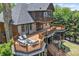 Multi-tiered deck overlooks meticulously maintained backyard with mature trees at 4290 Bobbins Way, Cumming, GA 30041