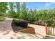 Expansive backyard featuring a basketball court, garden bed, and lush greenery at 4290 Bobbins Way, Cumming, GA 30041