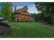 Spacious backyard of a multi-level home with stone accents, decks and ample green space at 4290 Bobbins Way, Cumming, GA 30041