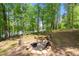 Natural backyard firepit with wooded surroundings and lake views at 4290 Bobbins Way, Cumming, GA 30041