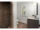 Bathroom features a granite countertop, tiled shower and window with shutters at 4290 Bobbins Way, Cumming, GA 30041