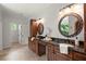 Dual wooden vanities with dark granite countertops in luxurious bathroom at 4290 Bobbins Way, Cumming, GA 30041