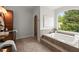 Bathroom features a soaking tub under a large window at 4290 Bobbins Way, Cumming, GA 30041