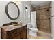 Bathroom with beautiful marble vanity, toilet, and tiled shower with mosaic accents at 4290 Bobbins Way, Cumming, GA 30041