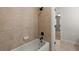 Bathroom features tan tile surround the bathtub, a black shower head and tap, and entrance to the Primary suite at 4290 Bobbins Way, Cumming, GA 30041