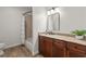 Bathroom features a granite counter, dark cherry cabinets, and a tub with a shower and curtain at 4290 Bobbins Way, Cumming, GA 30041