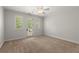 Bedroom with a ceiling fan, windows, and door to balcony at 4290 Bobbins Way, Cumming, GA 30041